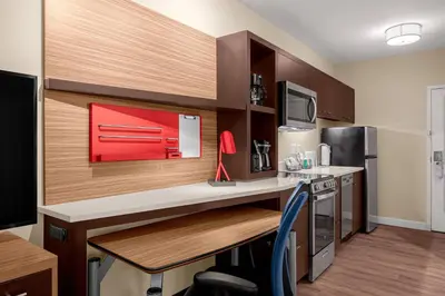 a small kitchen with a desk and a counter top at TownePlace Suites Cincinnati Fairfield in Fairfield