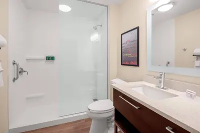 a bathroom with a shower and a toilet and a sink at TownePlace Suites Cincinnati Fairfield in Fairfield