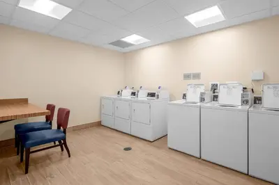 a room with a row of washers and dryers at TownePlace Suites Cincinnati Fairfield in Fairfield