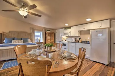 a kitchen and dining room with a table and a bed at Chic Main Street Retreat Less Than 7 Mi to KY Horse Park! in Georgetown