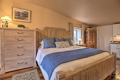 a bedroom with a large bed and a dresser at Chic Main Street Retreat Less Than 7 Mi to KY Horse Park! in Georgetown