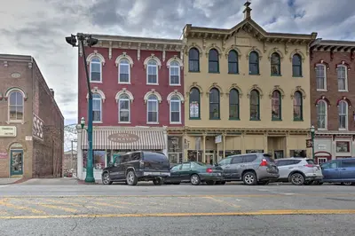 a city street with cars parked in front of buildings at Chic Main Street Retreat Less Than 7 Mi to KY Horse Park! in Georgetown