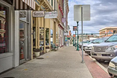a city street with cars parked on the sidewalk at Chic Main Street Retreat Less Than 7 Mi to KY Horse Park! in Georgetown