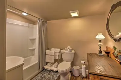 a bathroom with a toilet and a tub and a sink at Chic Main Street Retreat Less Than 7 Mi to KY Horse Park! in Georgetown
