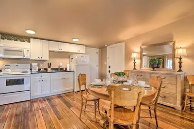 a kitchen with a table and chairs in a kitchen at Chic Main Street Retreat Less Than 7 Mi to KY Horse Park! in Georgetown