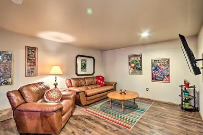a living room with leather furniture and a table at Butler Cabin on 19 Acres with Hot Tub and Fire Pit! in Butler