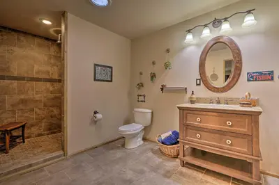 a bathroom with a toilet and a sink and a shower at Butler Cabin on 19 Acres with Hot Tub and Fire Pit! in Butler