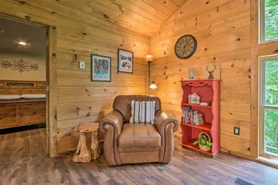 a leather chair in a room with wooden walls at Butler Cabin on 19 Acres with Hot Tub and Fire Pit! in Butler