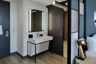 a bathroom with a sink and a mirror at Aloft Columbus in Columbus