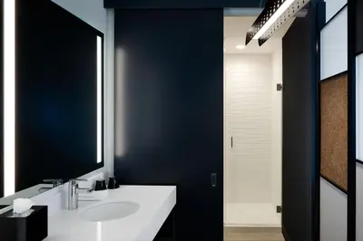 a bathroom with a white sink and a mirror at Aloft Columbus in Columbus