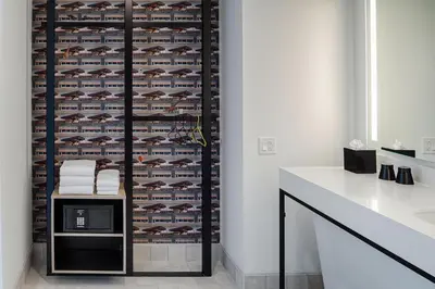a bathroom with a wall of wine racks at Aloft Columbus in Columbus