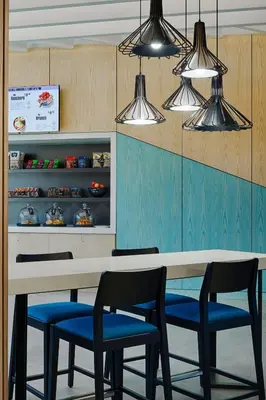 a dining room with a table and four chairs at Aloft Columbus in Columbus