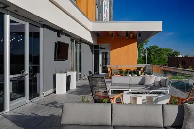 a patio with couches and chairs on a building at Aloft Columbus in Columbus
