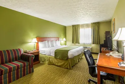 a hotel room with a bed and a desk at Quality Inn Weston in Weston