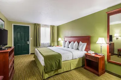a hotel room with a bed and a television at Quality Inn Weston in Weston
