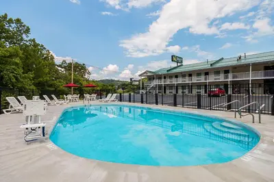 a swimming pool in front of a hotel at Quality Inn Weston in Weston