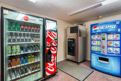 a soda machine and a drink cooler in a store at Quality Inn Weston in Weston