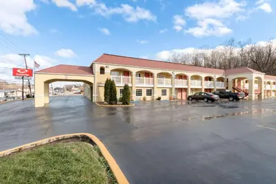 a large building with a parking lot in front of it at Econo Lodge Huntington - Barboursville University Area in Huntington