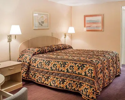 a hotel room with a bed and two lamps at Rodeway Inn Findlay University Area in Findlay