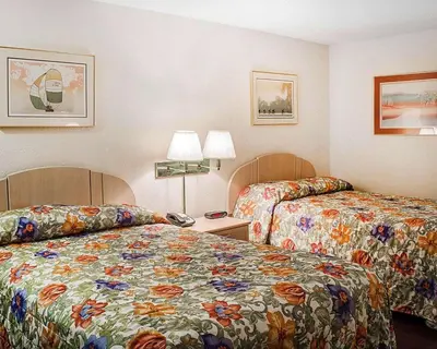 a hotel room with two beds and a phone at Rodeway Inn Findlay University Area in Findlay