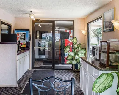a kitchen with a door leading into a store at Rodeway Inn Findlay University Area in Findlay