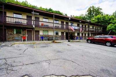 a red car parked in front of a building at OYO Hotel Chapmanville Inn, WV - Hwy 119 in Chapmanville