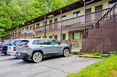 a row of cars parked in front of a building at OYO Hotel Chapmanville Inn, WV - Hwy 119 in Chapmanville