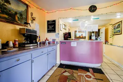 a kitchen with a counter and a pink refrigerator at OYO Hotel Chapmanville Inn, WV - Hwy 119 in Chapmanville