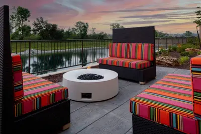 a patio with two chairs and a table and a fire pit at Hilton Garden Inn By Hilton Fort Wayne North in Sunnybrook Acres