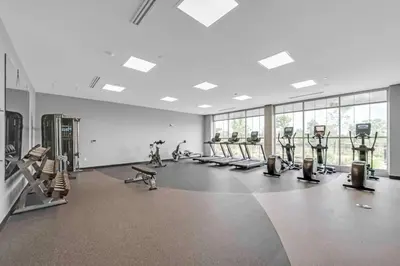 a gym with rows of treadmills and machines at Hilton Garden Inn By Hilton Fort Wayne North in Sunnybrook Acres