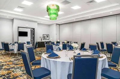 a conference room with tables and chairs and a chandelier at Hilton Garden Inn By Hilton Fort Wayne North in Sunnybrook Acres