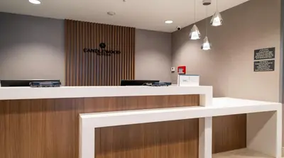 a lobby with a reception counter with a sign on the wall at Candlewood Suites - Cleveland South - Independence by IHG in Independence