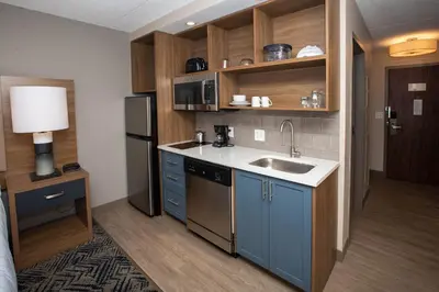 a small kitchen with a sink and a refrigerator at Candlewood Suites - Cleveland South - Independence by IHG in Independence