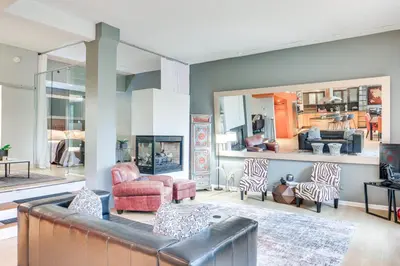 a living room with a leather couch and zebra chairs at Dtwn Cleveland Loft-Style Condo Walk to Stadiums! in Cleveland