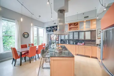 a kitchen and dining room with a table and chairs at Dtwn Cleveland Loft-Style Condo Walk to Stadiums! in Cleveland