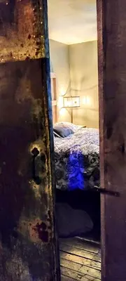 an open door to a bedroom with a bed at Hocking Hills Rusty Lofts in Logan