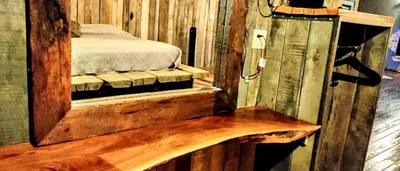 a bedroom with a mirror and a bed in it at Hocking Hills Rusty Lofts in Logan