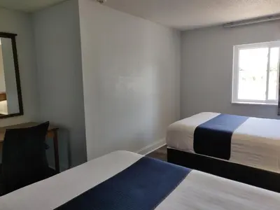a room with two beds and a window at Cedar Cove in Sandusky