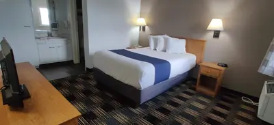 a hotel room with a bed and a bathroom at Cedar Cove in Sandusky