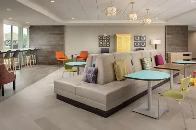 a lobby with a couch and tables and chairs at Home2 Suites By Hilton Marysville in Marysville