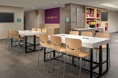 a conference room with white tables and chairs at Home2 Suites By Hilton Marysville in Marysville