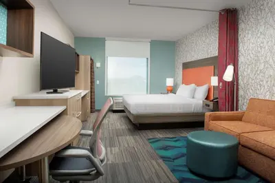 a hotel room with a bed and a desk at Home2 Suites By Hilton Marysville in Marysville