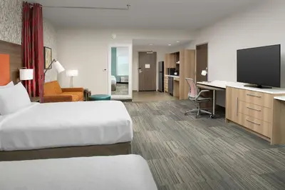 a hotel room with a bed and a desk with a television at Home2 Suites By Hilton Marysville in Marysville