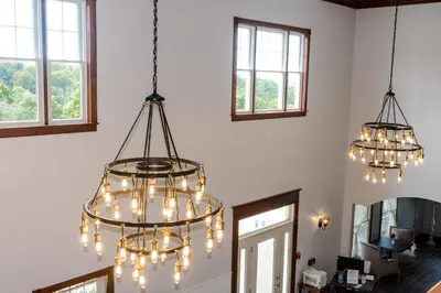a room with three chandeliers hanging from the ceiling at Hillside Villa Ohio in Millersburg