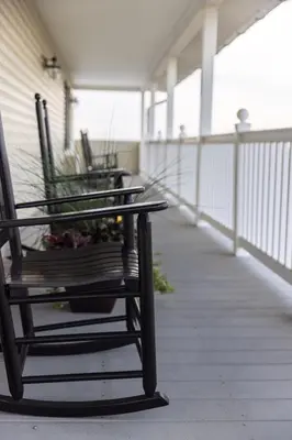 a bench sitting on the porch of a house at Hillside Villa Ohio in Millersburg