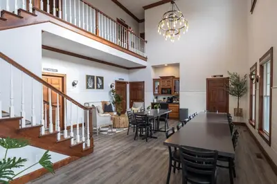 a dining room and living room with a table and chairs at Hillside Villa Ohio in Millersburg