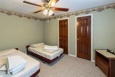 a bedroom with two beds and a ceiling fan at Hillside Villa Ohio in Millersburg