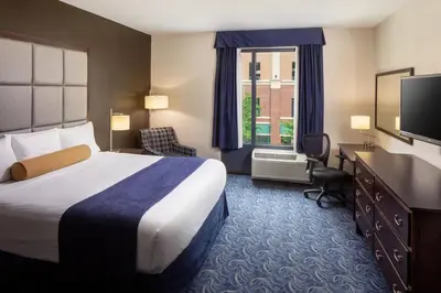 a hotel room with a bed and a desk and a television at Kent State University Hotel and Conference Center in Kent