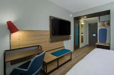 a hotel room with a bed and a tv and a desk at Tru By Hilton Grove City Columbus in Grove City