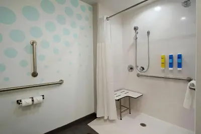 a bathroom with a shower and a toilet at Tru By Hilton Grove City Columbus in Grove City